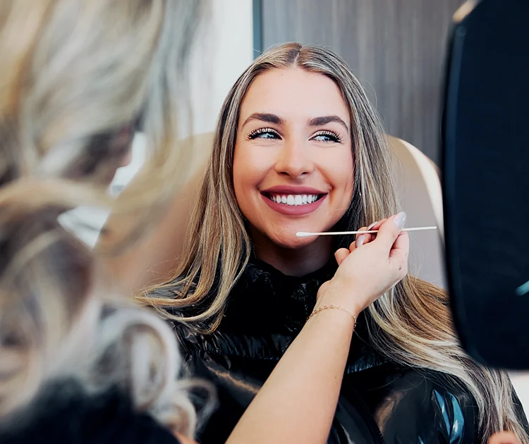 woman smiling while receiving dermal filler