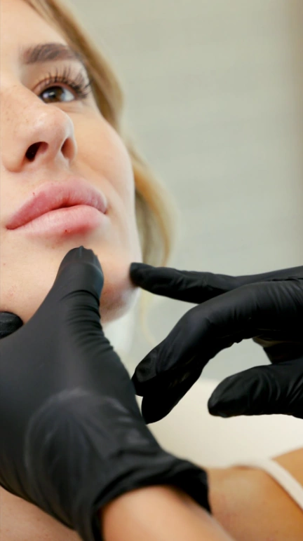 injector at myevergreen medspa assessing patient during lip filler consultation