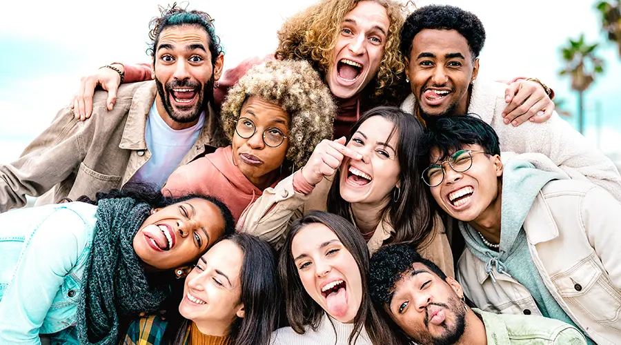 multi cultural guys and girls taking photo