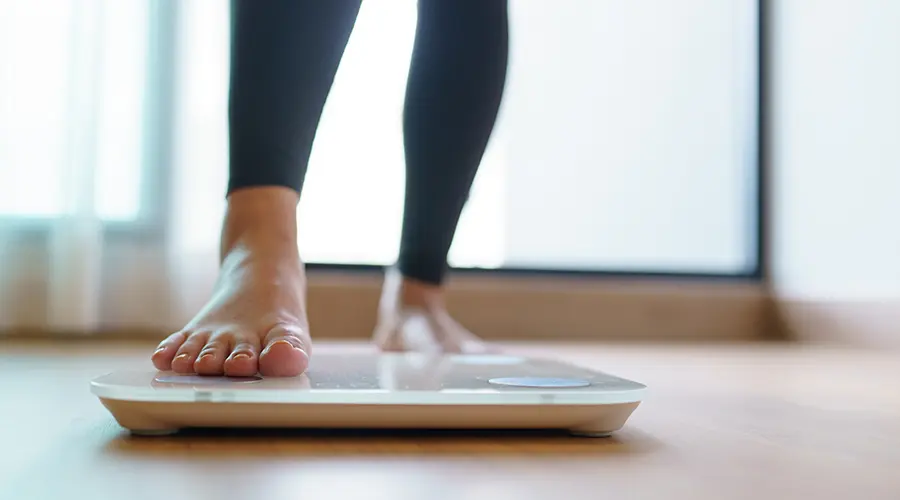 woman stepping on a scale